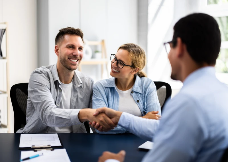 Smiling couple meeting with professional