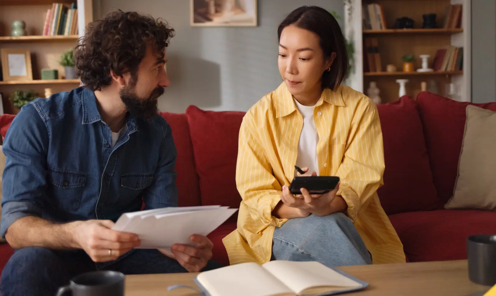 Pair sitting with papers and tablet