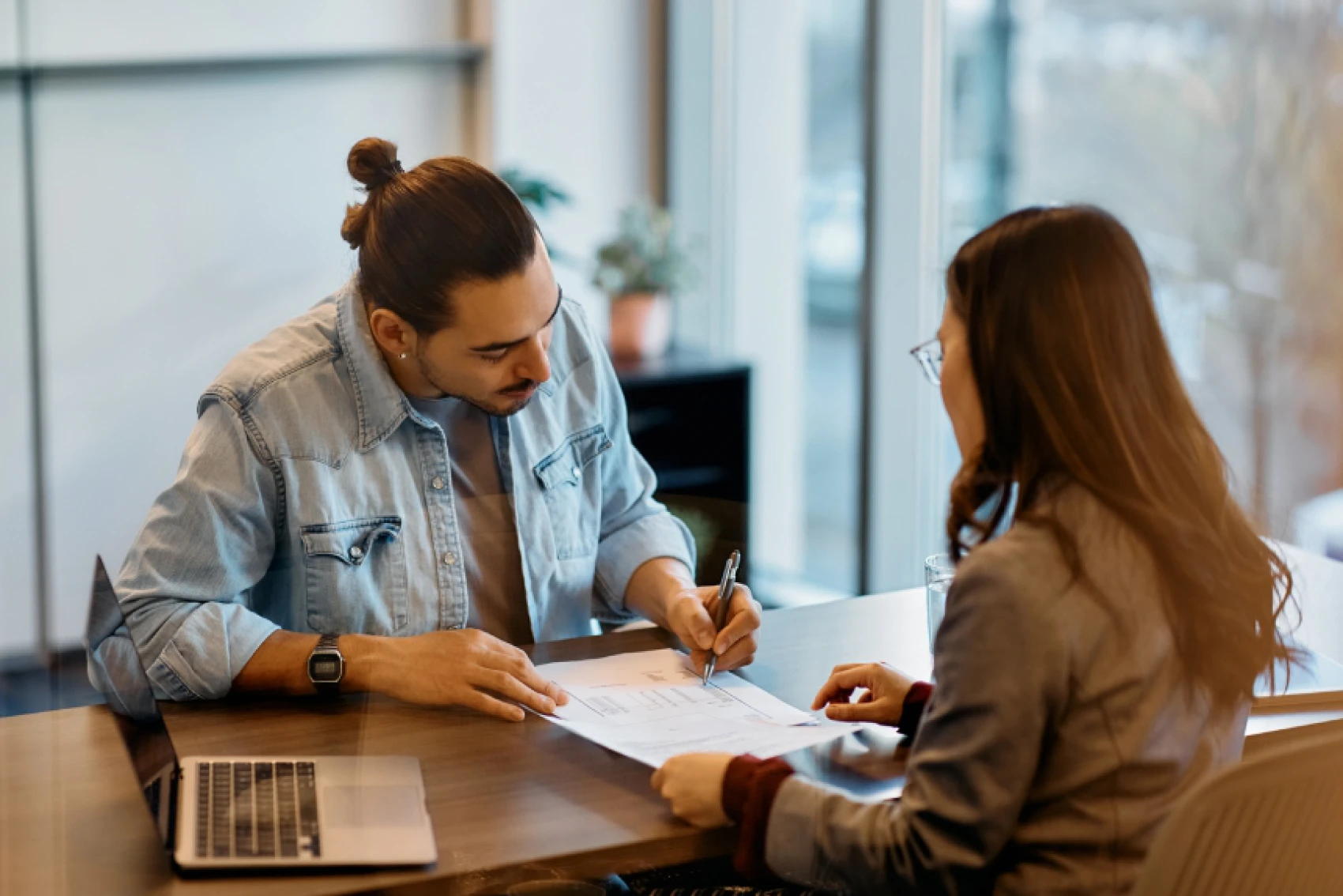Colleagues discussing work in office setting